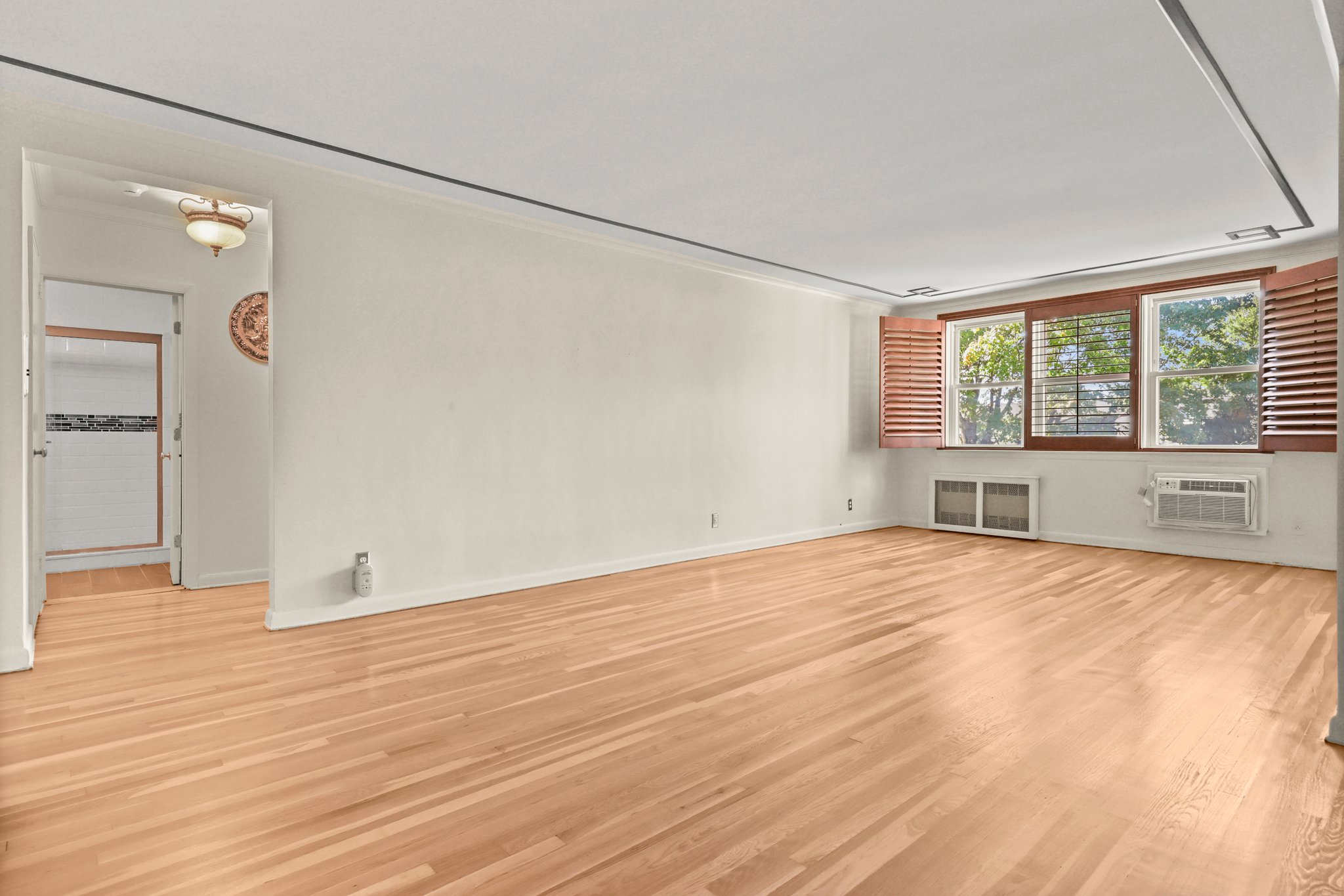 Living Room to Hall. Custom wood plantation shutters.