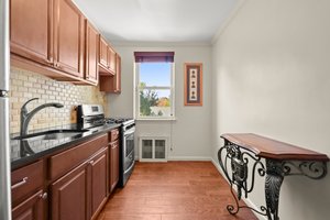 Eat-in Kitchen with wood cabinetry, custom wood blinds