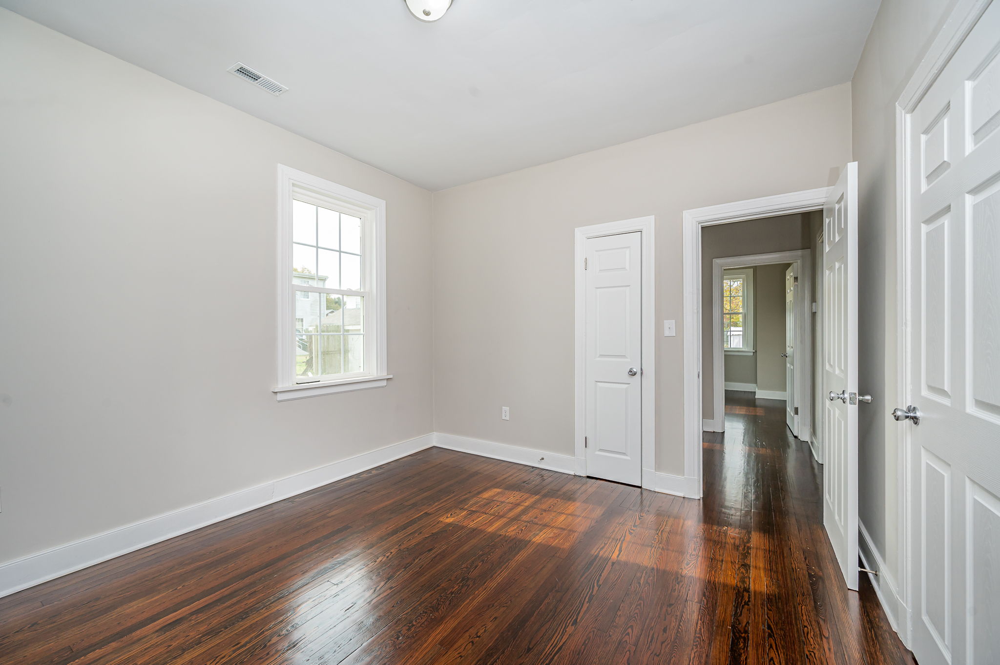 Front bedroom with beautiful refinished hardwood floors, fresh paint and all new doors