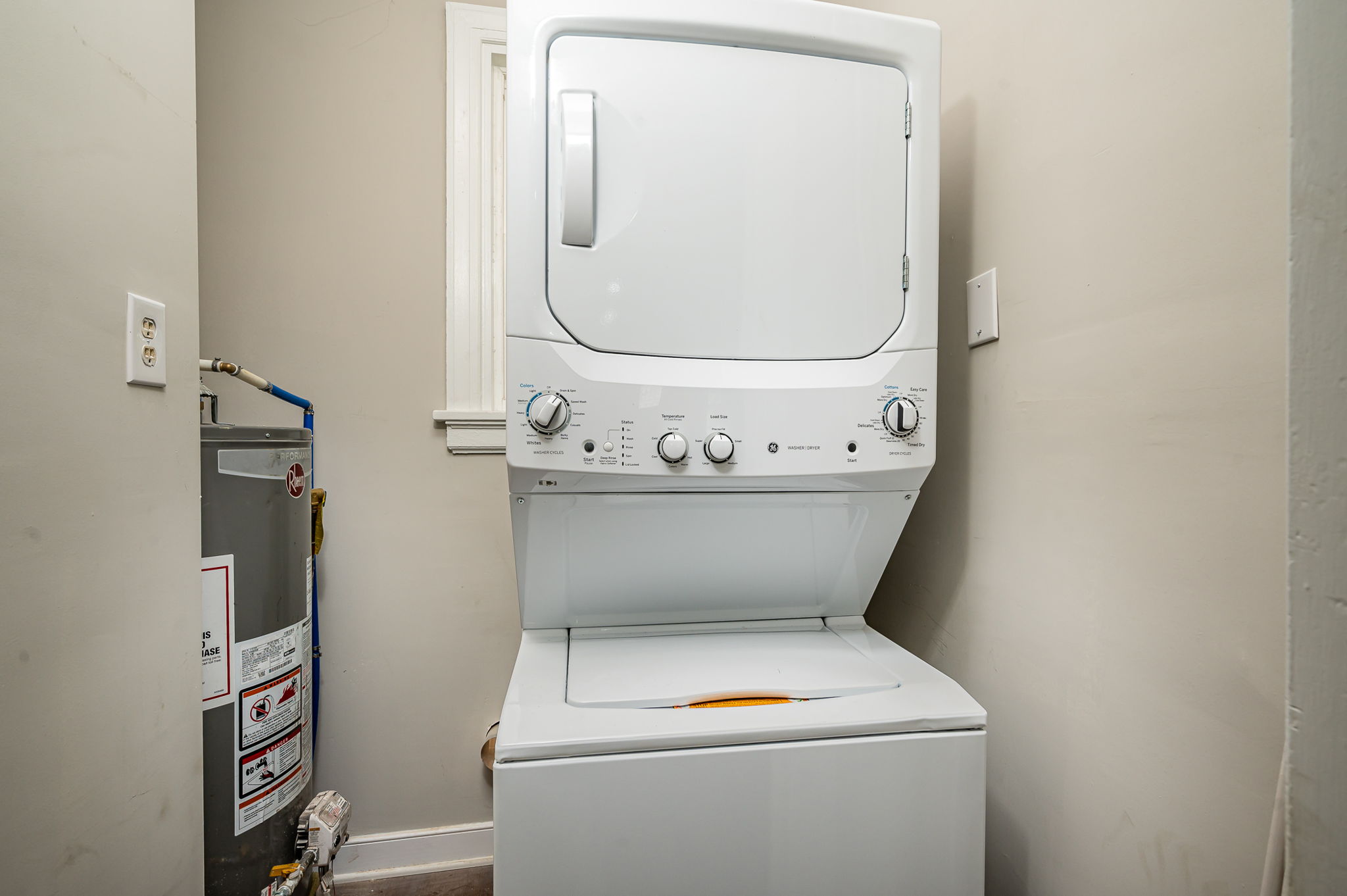 Separate laundry area with brand new washer dryer unit. New water heater