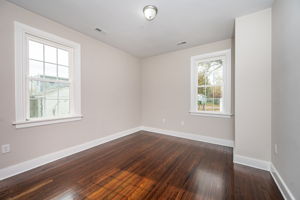 2nd bedroom with refinished hardwood floors, fresh paint, new lighting fixture