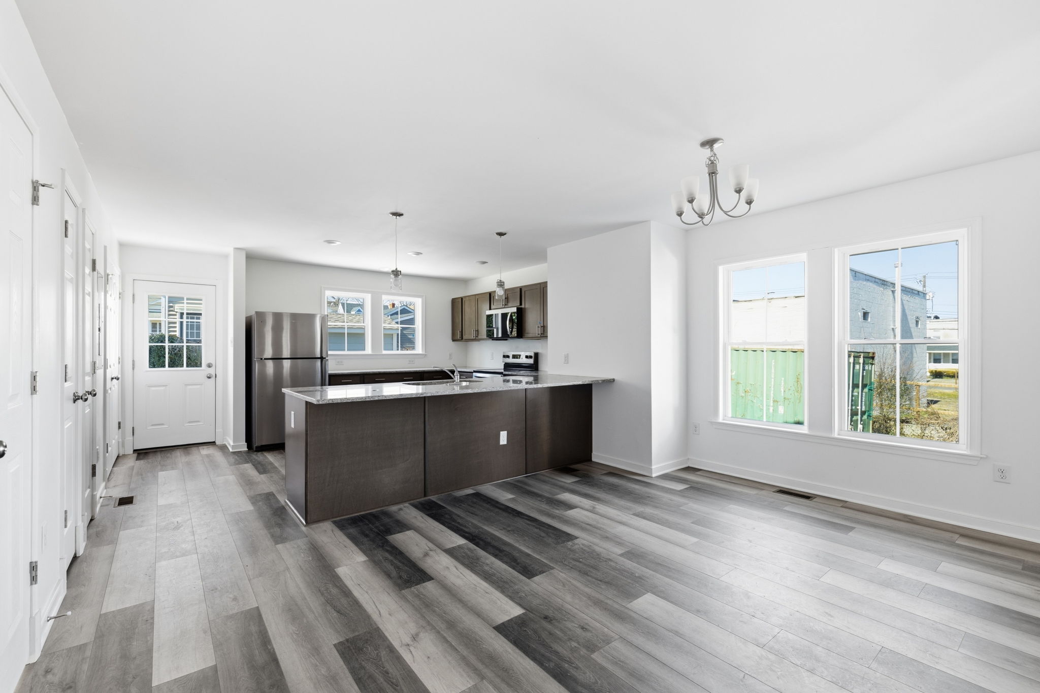 Large kitchen with breakfast bar seating at peninsula and space for a table.