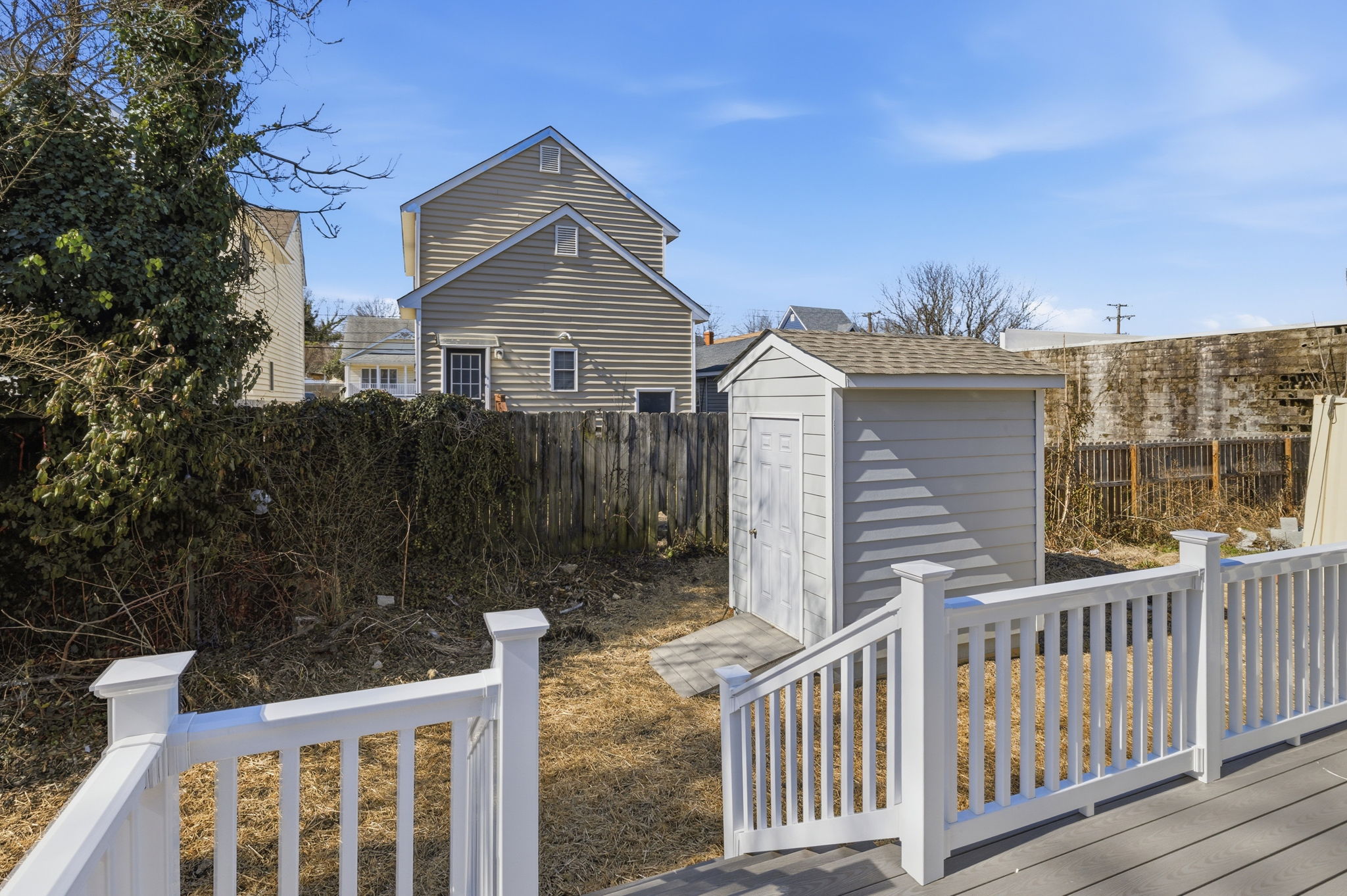 Back yard with brand new detached storage shed with low maintenance hardi-plank siding.