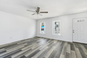 High quality LVP flooring throughout, ceiling fan, with access to the covered front sitting porch highlight the first floor living area.