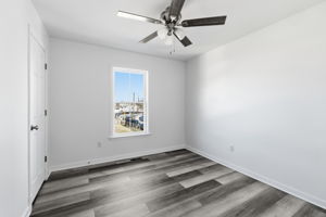 Guest bedroom number 2 with LVP flooring, ceiling fan, and a nice sized closet.