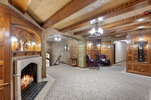 The inviting lobby exudes timeless elegance, with impeccably maintained millwork, stunning stained-glass Art Deco details, a cozy fireplace, and a classic gated elevator that whispers of a bygone era.