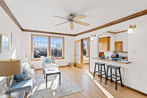 Perched on the top floor, this sun-drenched living room is your private retreat in the sky. Original leaded glass windows frame captivating cityscapes and golden sunsets, filling the space with warmth and timeless charm.