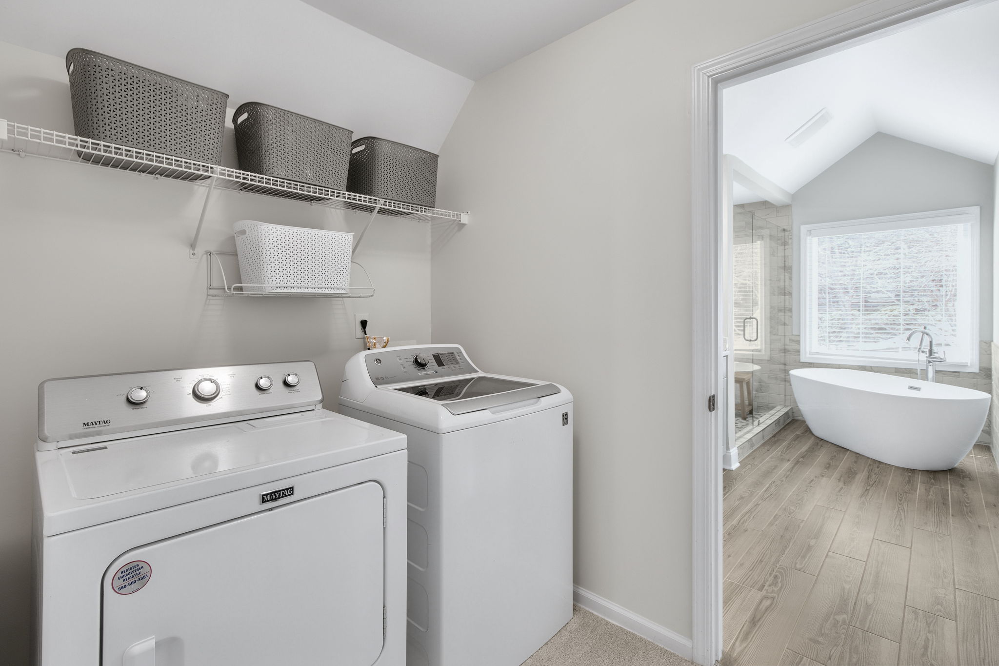 Conveniently located upstairs, the laundry room offers easy access from both the primary bathroom and hallway, making laundry day effortless and efficient.