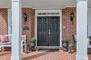 The grand double-door entrance sets the tone for the beautiful interior. With ample seating space, the porch is a perfect spot to enjoy peaceful mornings or unwind in the evening.