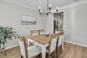 The dining room effortlessly connects to the kitchen, providing an inviting space for entertaining and soft neutral tones.