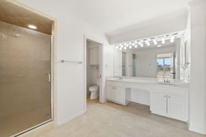 The primary bath includes dual vanities, a large walk-in shower, a separate water closet, and two walk in closets (in addition to the third closet within the bedroom)