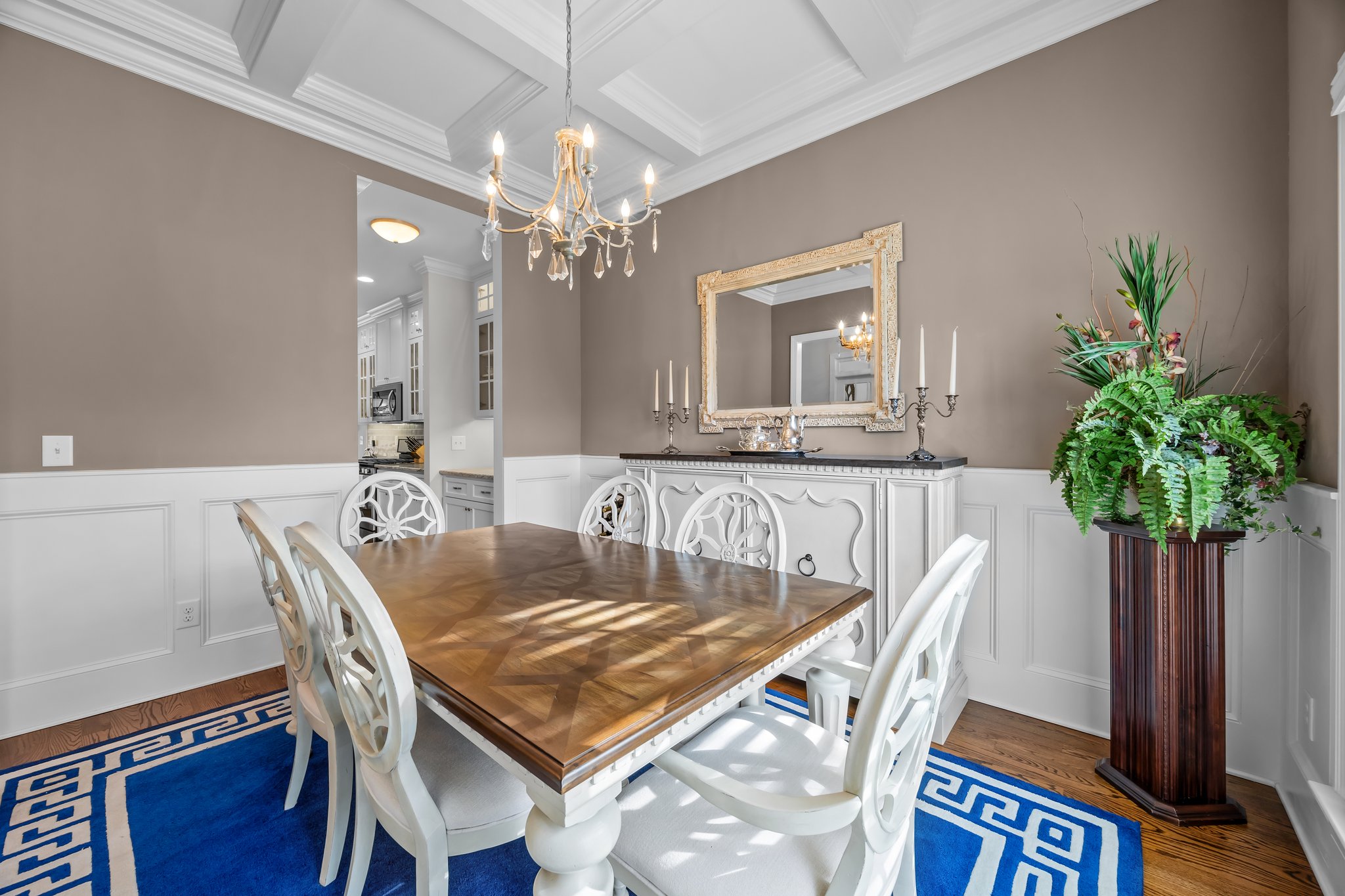 Classic dining room with coffered ceiling, wainscoting