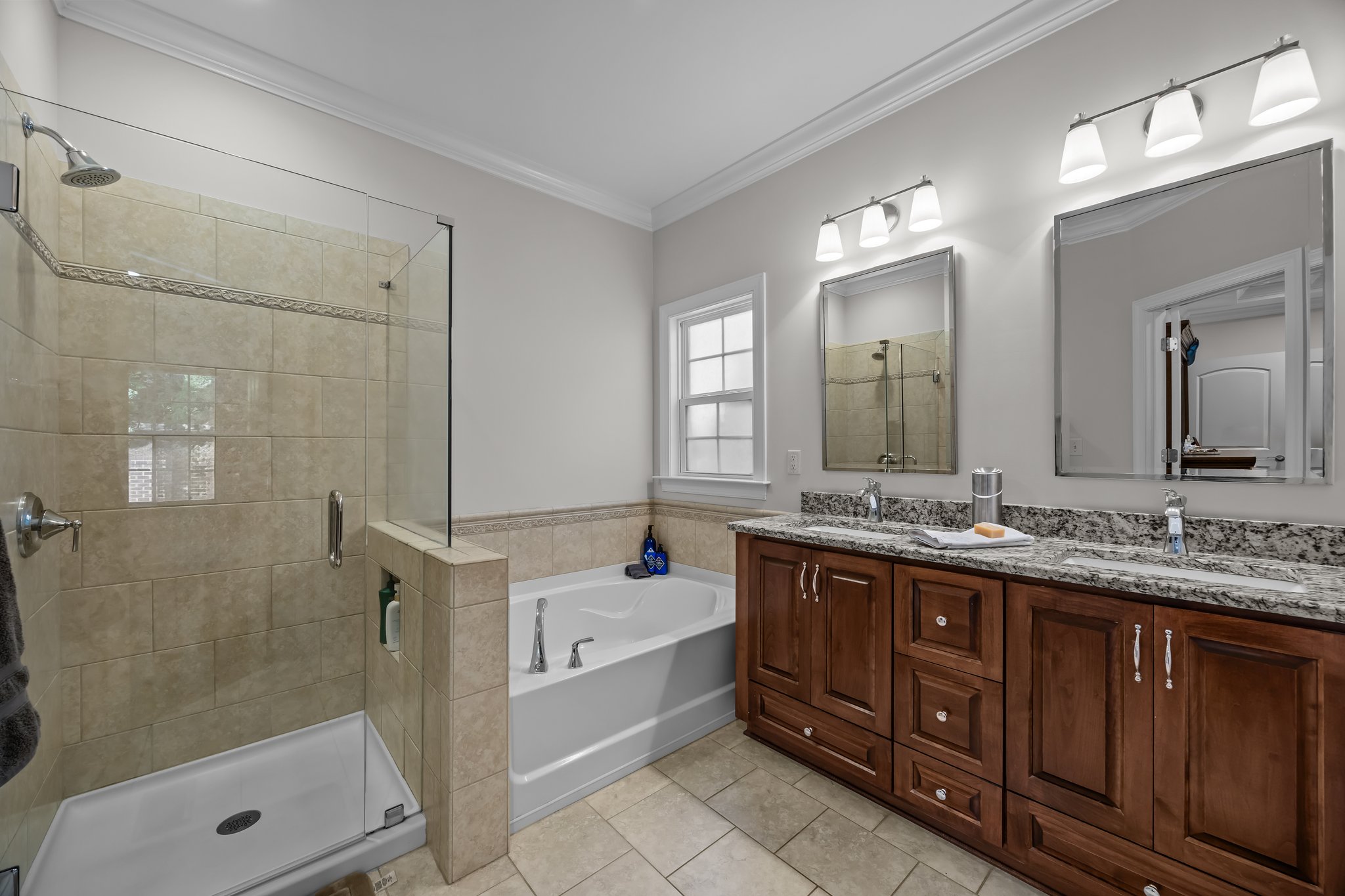 Glass enclosed tile shower, soaking tub, double granite vanity