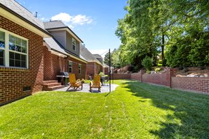 French drain installed behind brick retaining wall