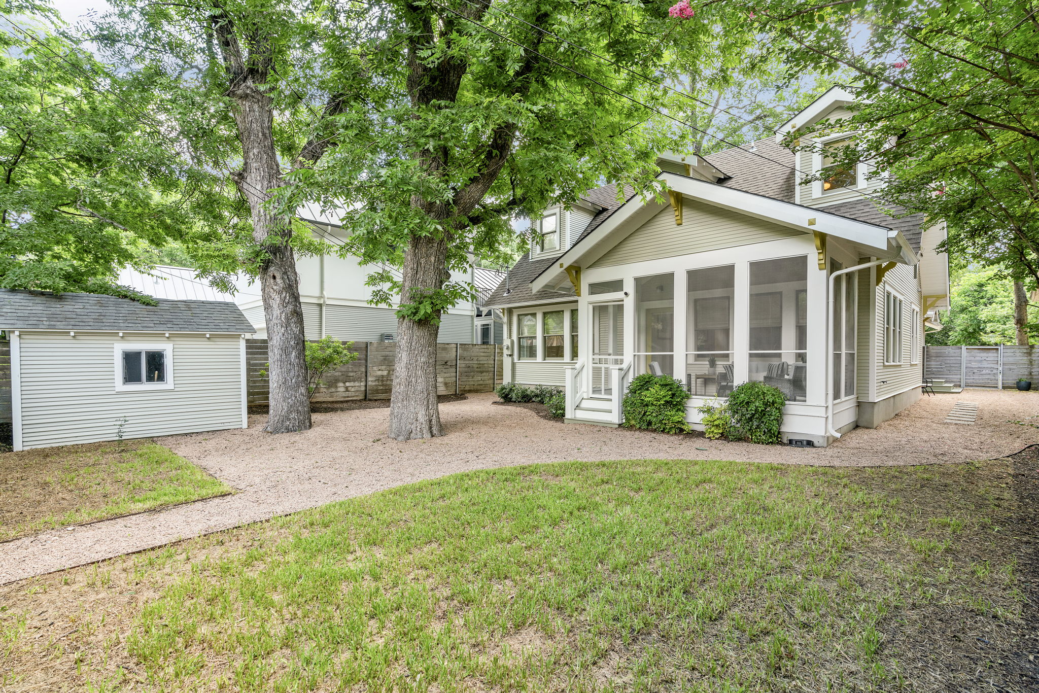 Enjoy the comfortable screen porch that overlooks a well-maintained backyard oasis. This private retreat offers a serene space for relaxation and play, complete with alley access for added convenience.