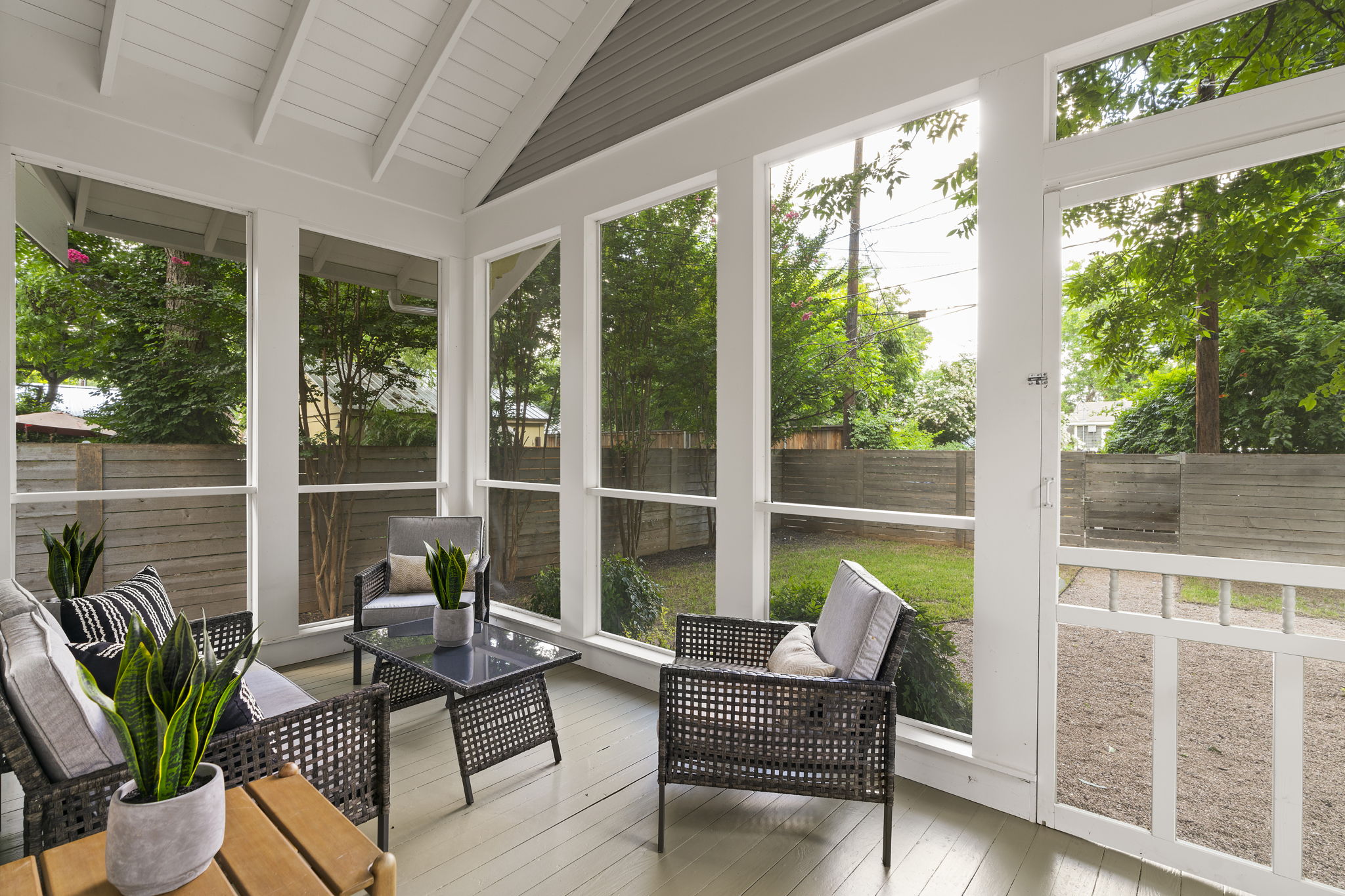 Enjoy the tranquil screened-in patio, a delightful space where comfort meets the natural beauty of the backyard.