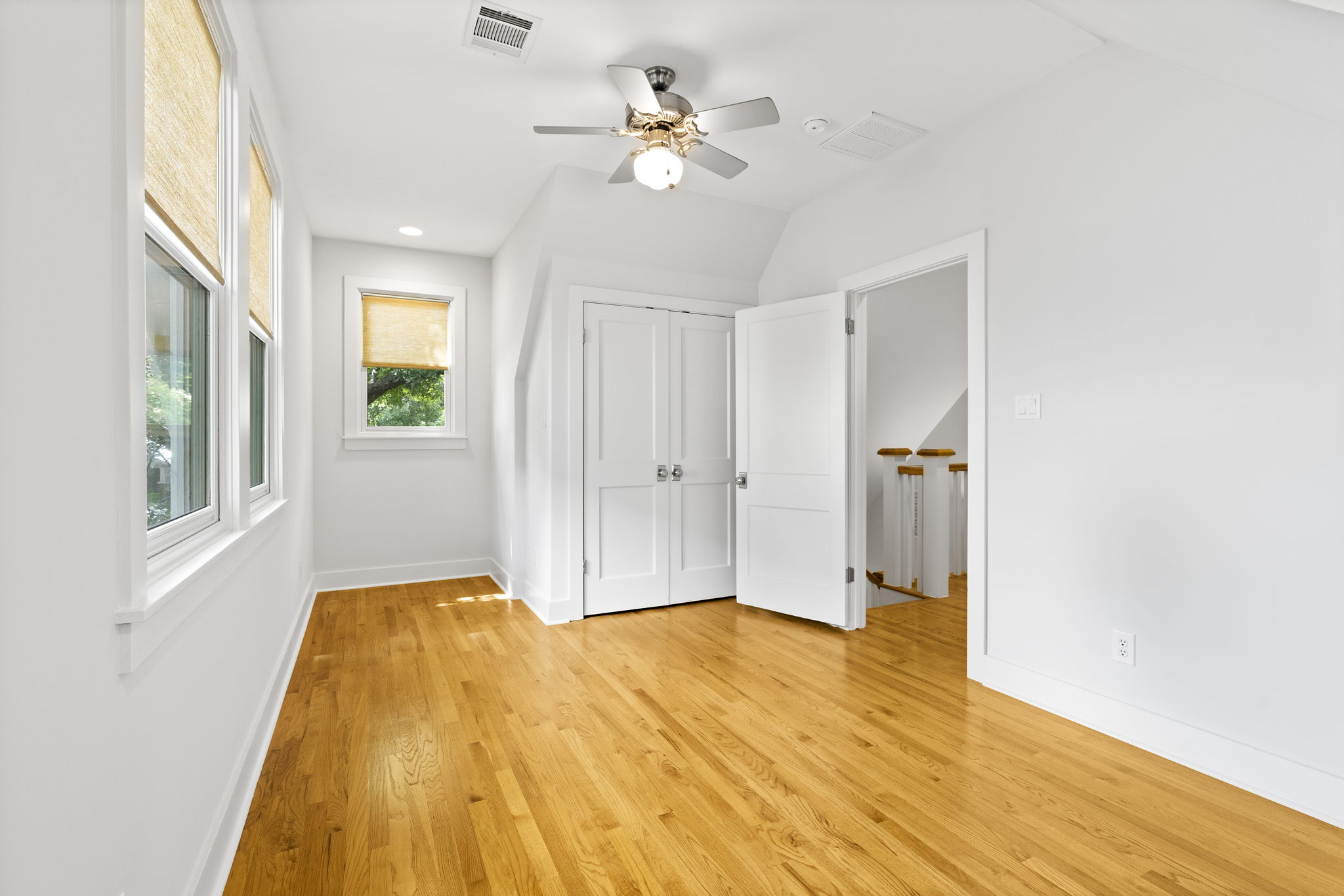 This additional bedroom is graced with large windows providing soothing natural light.