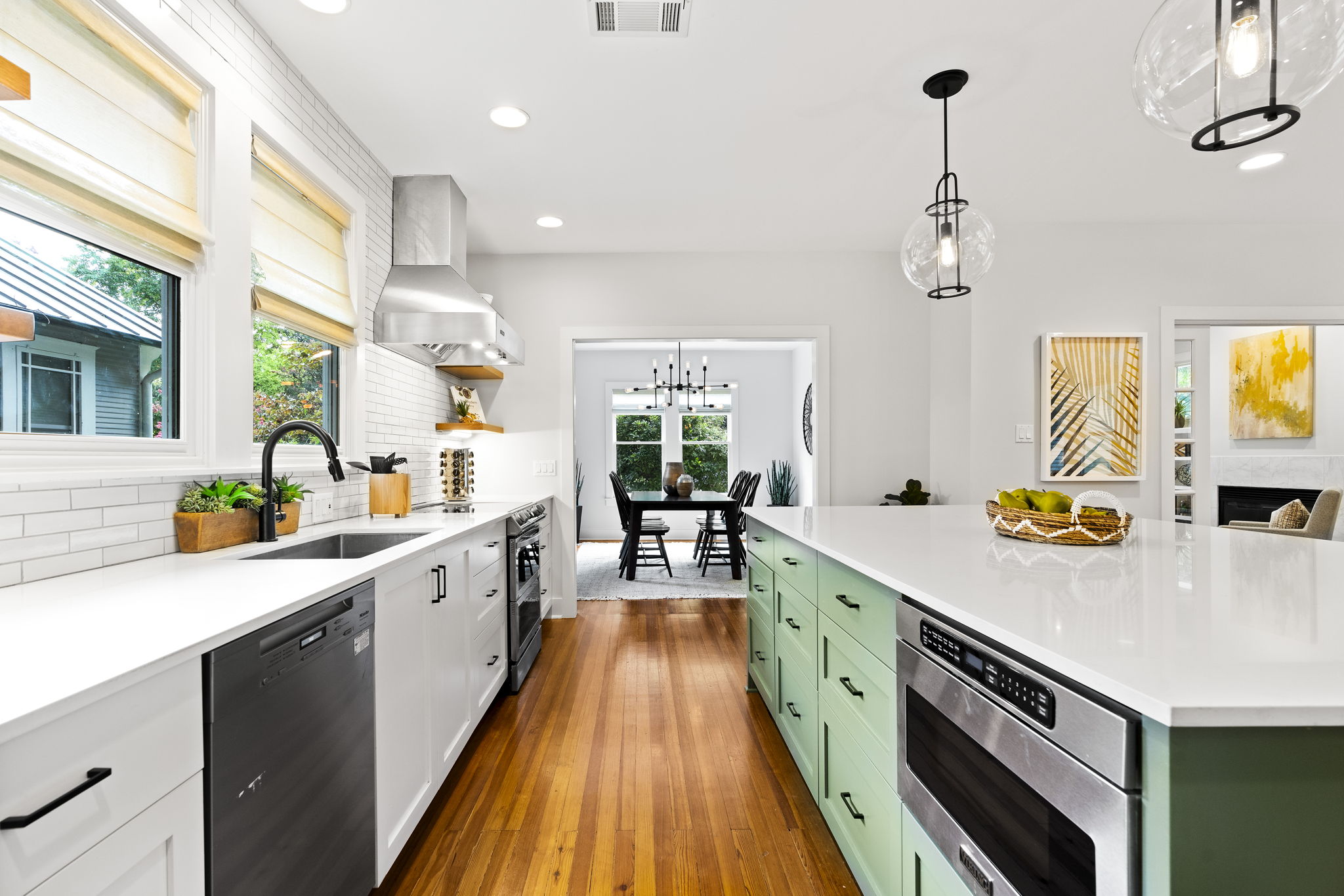 This expansive kitchen is an ideal space for both cooking and entertaining, offering abundant counter space, ample storage options, and a spacious serving area.