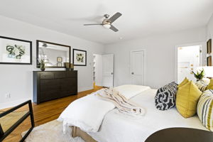 An alternate view of the main bedroom highlights entrances to the en suite bathroom and walk-in closet.