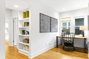 Escape to a secluded home office designed for productivity and relaxation, featuring built-in bookshelves that add versatility and charm to the workspace.