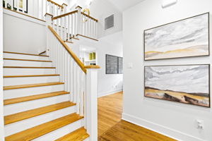 Admire the beautiful wood staircase, a striking feature that enhances the home's charm and character.