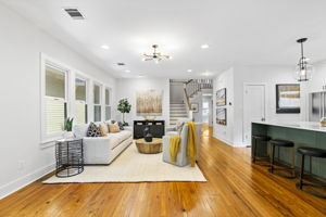 The open floor plan creates a spacious and fluid living environment, promoting connectivity and an airy feel. An optimal arrangement for unwinding with a book on the couch or engaging with the chef in the kitchen.