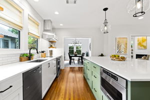 This expansive kitchen is an ideal space for both cooking and entertaining, offering abundant counter space, ample storage options, and a spacious serving area.