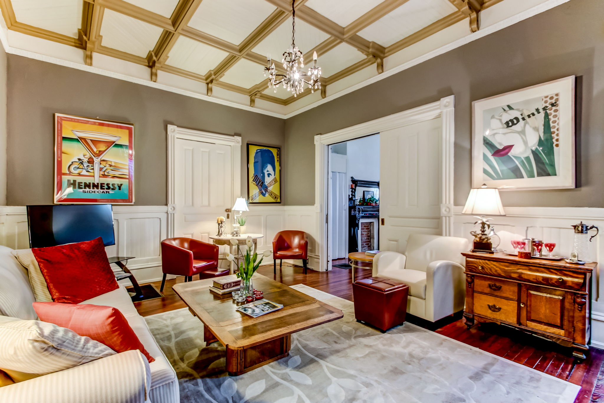 Main House Living Room with Crown molding on the ceiling, original hardwood floors, and chair railing