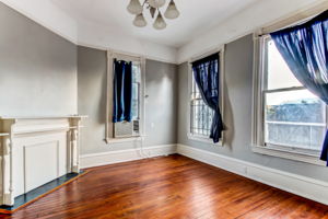 Spacious 2nd floor unit with fireplace, mantel, and original wood flooring