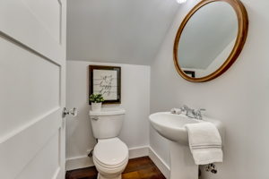 Powder room on first floor by stairs