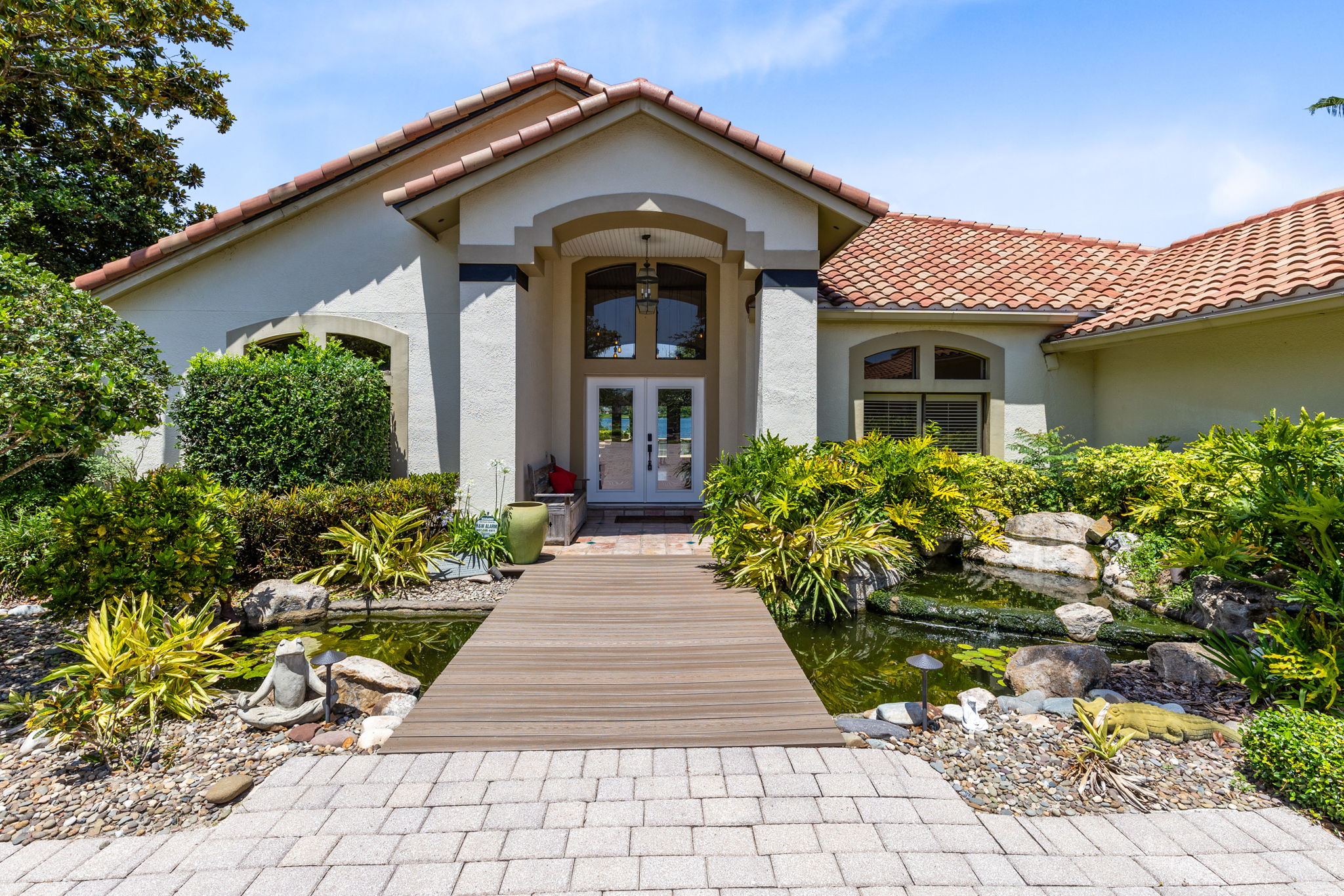 Unique entry with Trex bridge over a koi pond