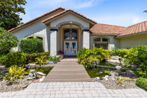 Unique entry with Trex bridge over a koi pond