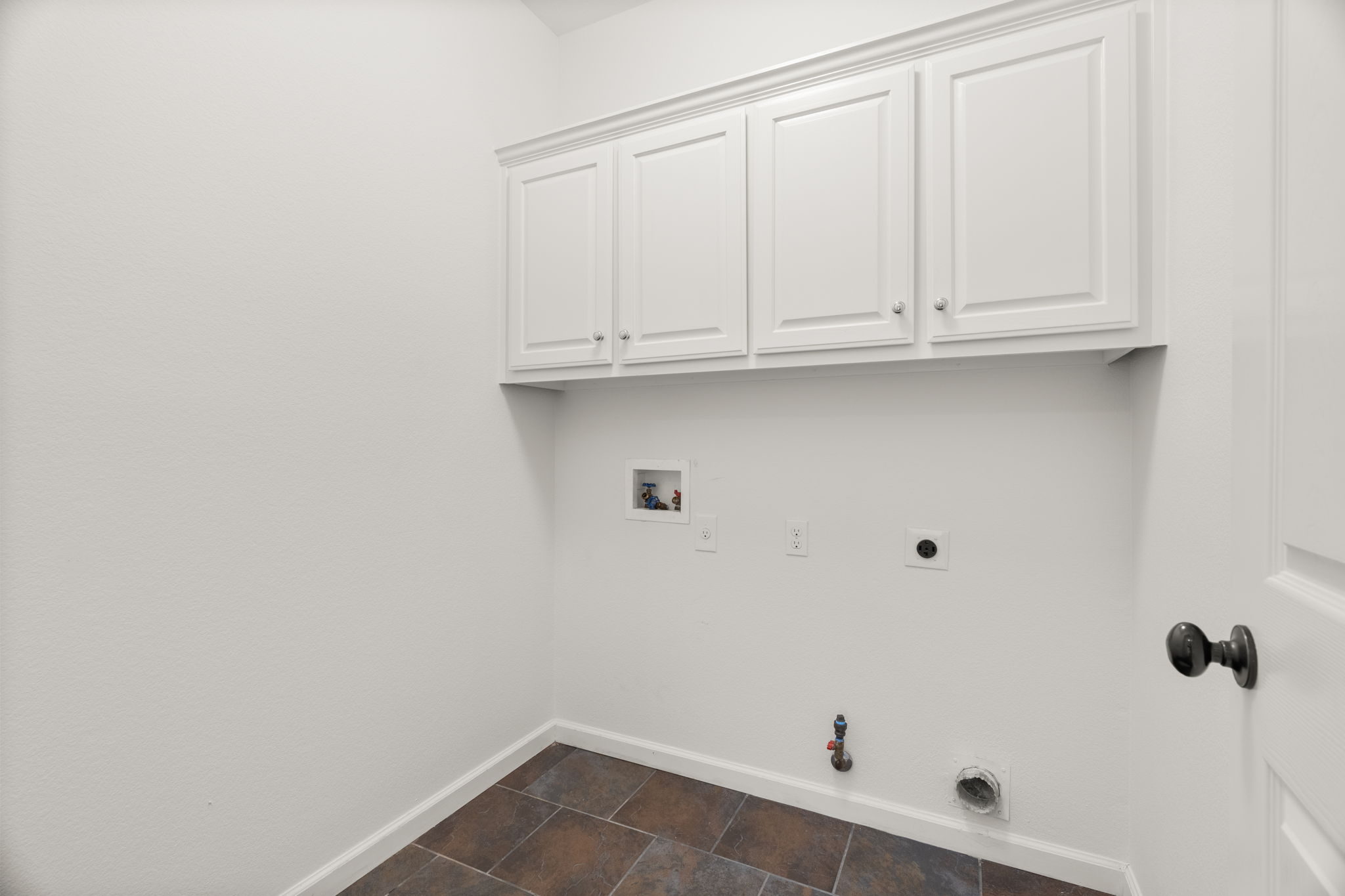 Lower-level laundry room near the door to the garage.