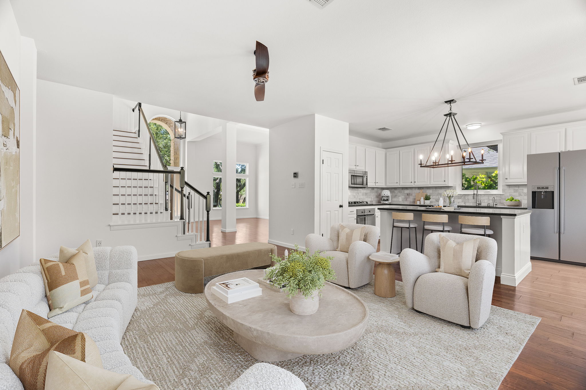 Virtually staged. At the heart of the home, the light-filled, well-appointed kitchen boasts a center island, gas cooktop, ample cabinetry and a cozy dining nook overlooking the lush backyard.