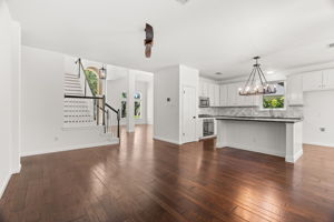 At the heart of the home, the light-filled, well-appointed kitchen boasts a center island, gas cooktop, ample cabinetry and a cozy dining nook overlooking the lush backyard.