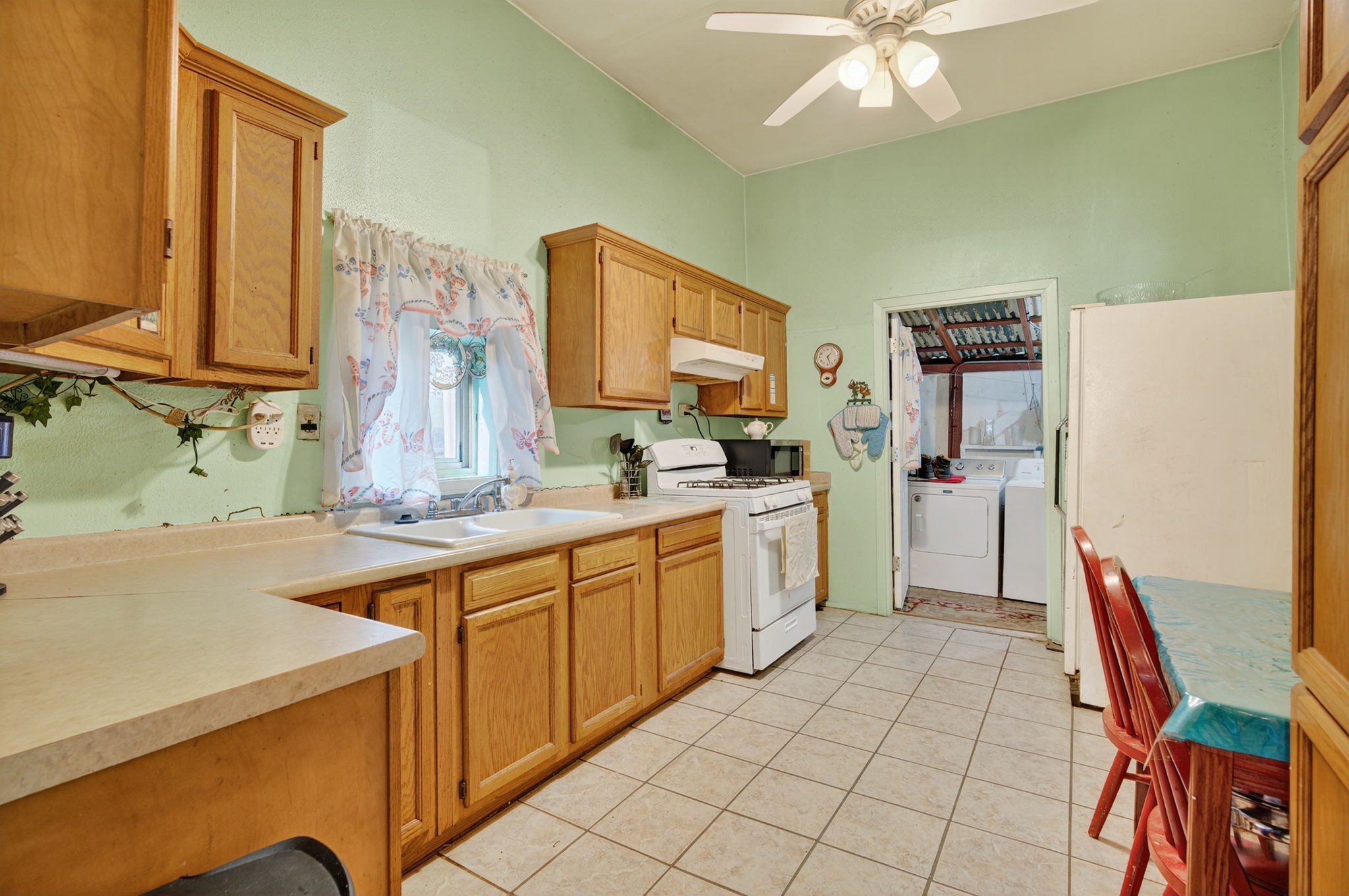 Your kitchen and breakfast area with updated tile flooring and attached laundry room.