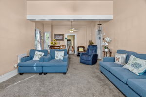 The living room seamlessly flows into the dinning room with updated carpet throughout.