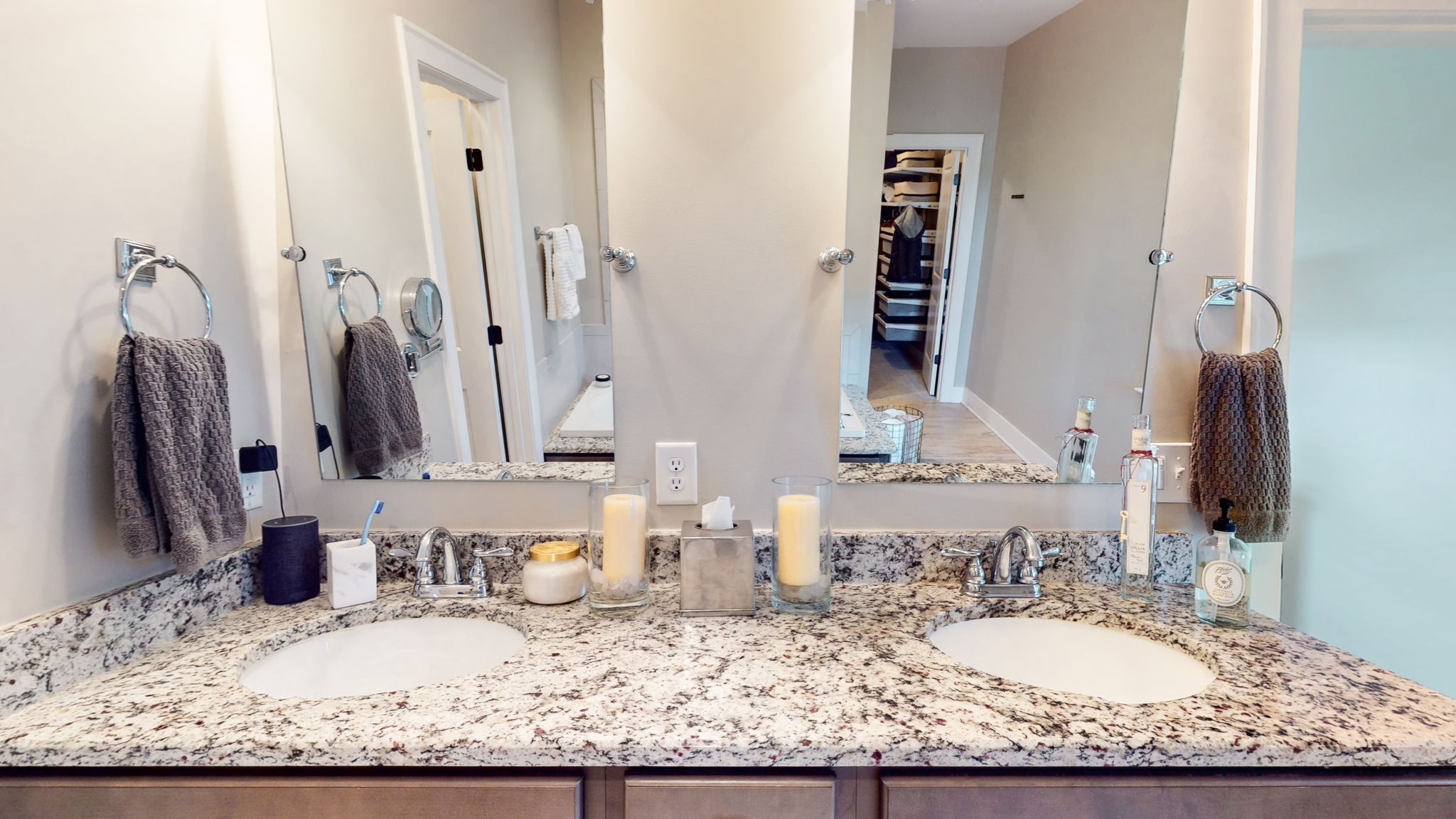 The double vanity has 2 sinks with undermount bowl sinks, plenty of storage, and individual vanity mirrors.