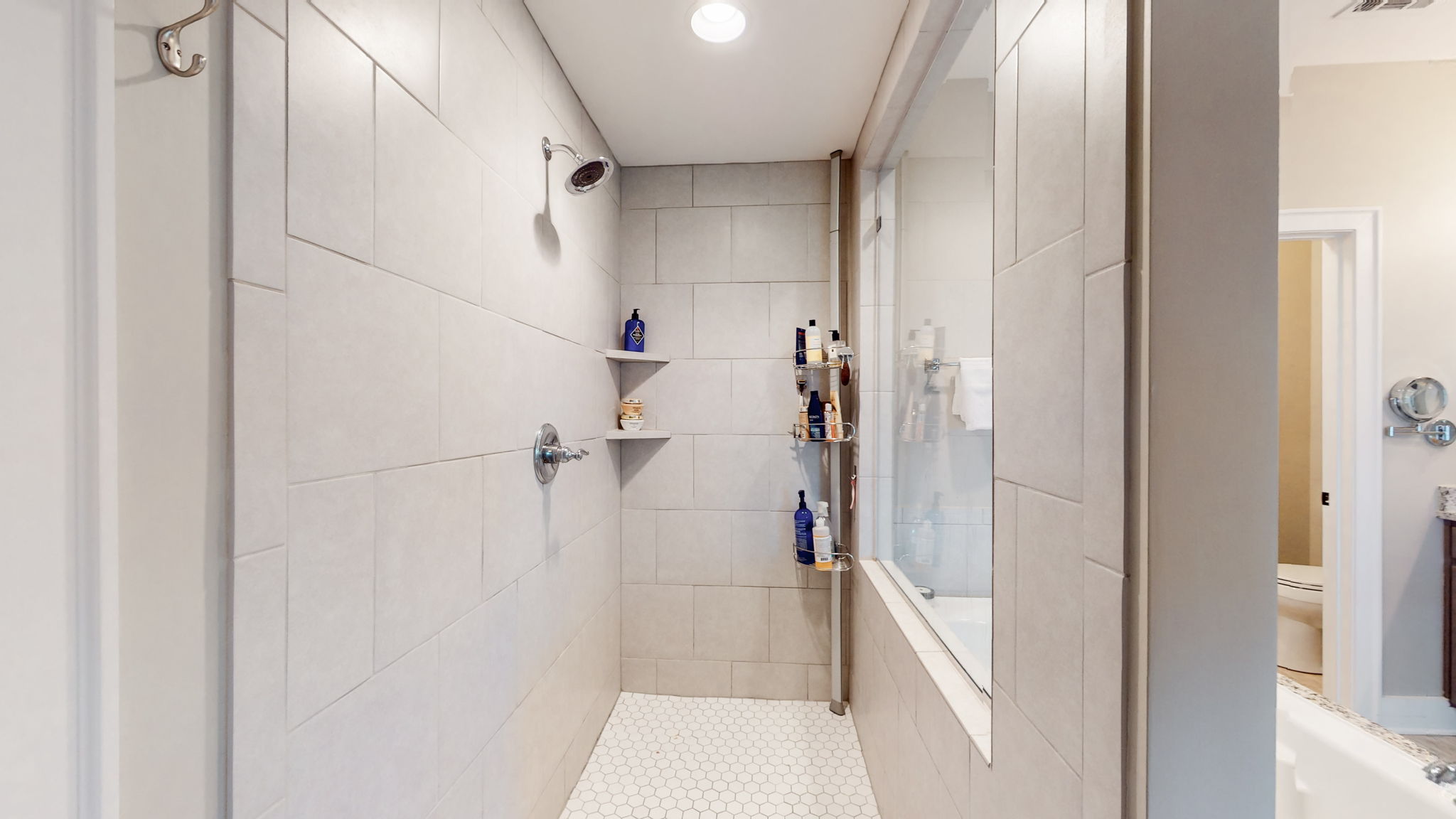 The extra large tiled shower is roomy and features easy in/out access.