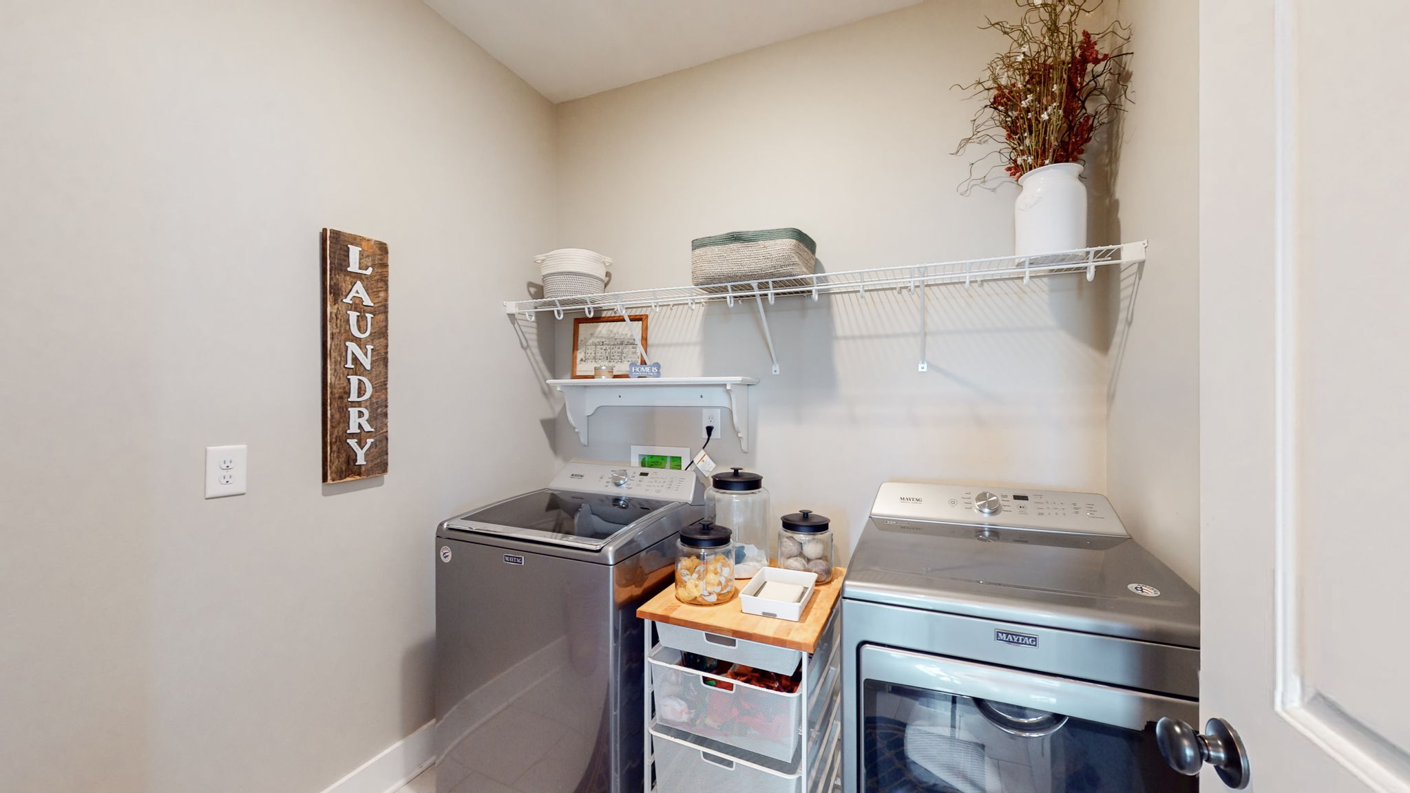 The laundry room has wire shelving, which can easily be upgraded to add cabinets if desired.