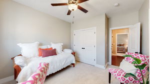 The front bedroom also features a custom large closet, carpet, and a ceiling fan.