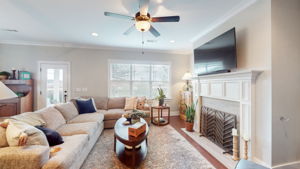 The living room is flooded with natural light and daily sunsets out the back windows.