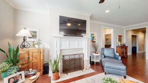 The living room features a gas fireplace, operated by a switch, and a decorative mantel surround.