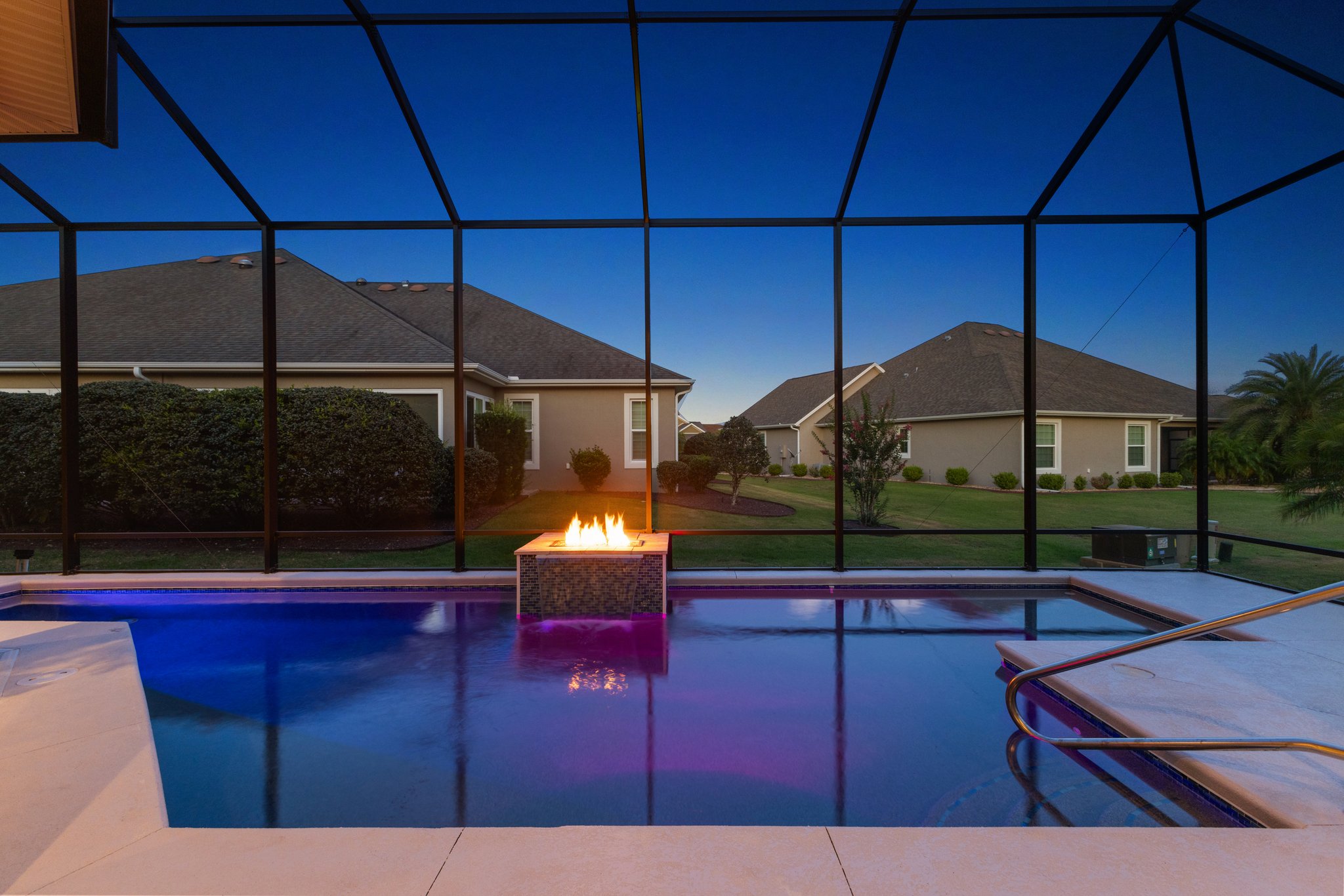 Twilight Swimming Pool with Waterfall and Fire Feature