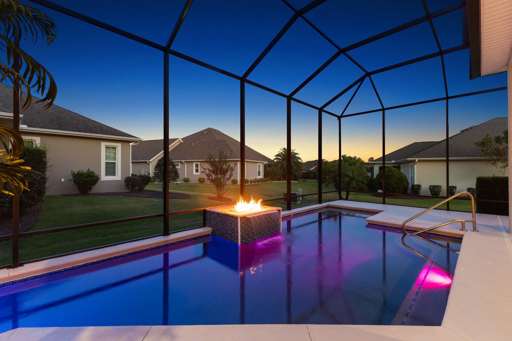 Twilight Swimming Pool with Waterfall and Fire Feature