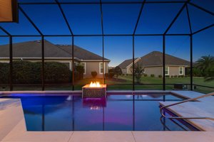 Twilight Swimming Pool with Waterfall and Fire Feature