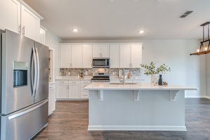 Kitchen features large island with quartz counters