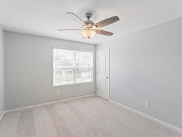 Additional bedroom with walk-in closet and ceiling fan