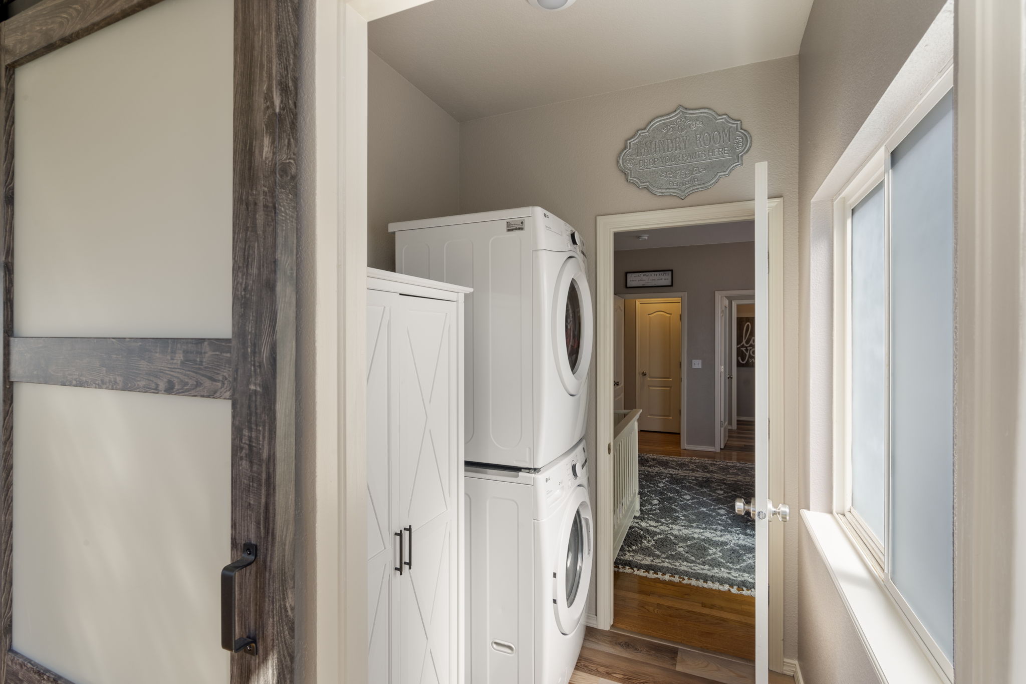 Laundry has barn door, armoire and stackable Washer/Dryer stay!