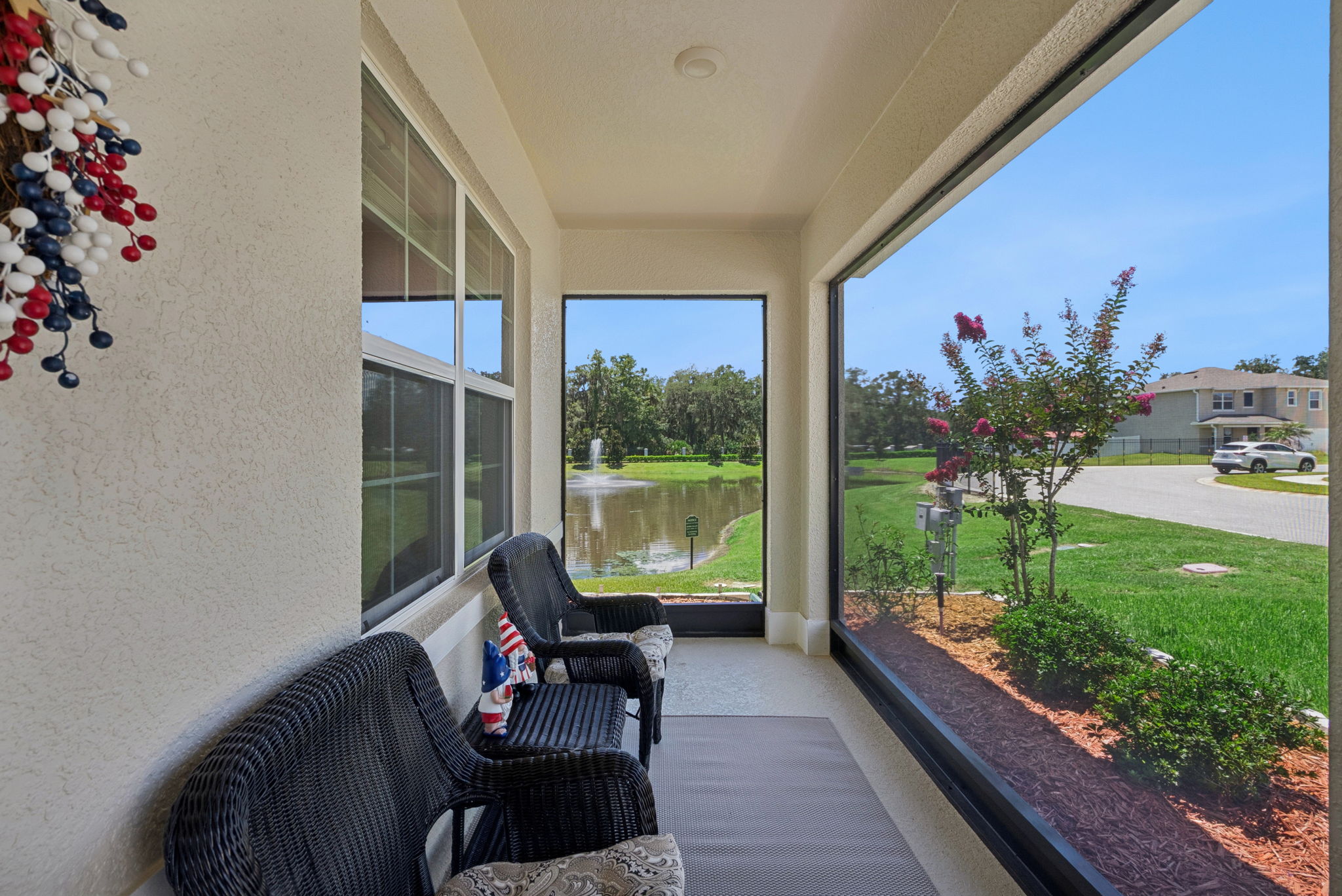 Relax on your screened front porch beside the pond